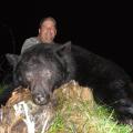 Bill with his big boar in the grass.
